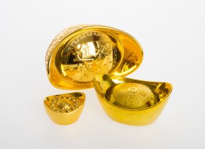 Gold or Chinese gold ingot mean symbols of wealth and prosperity on a background.