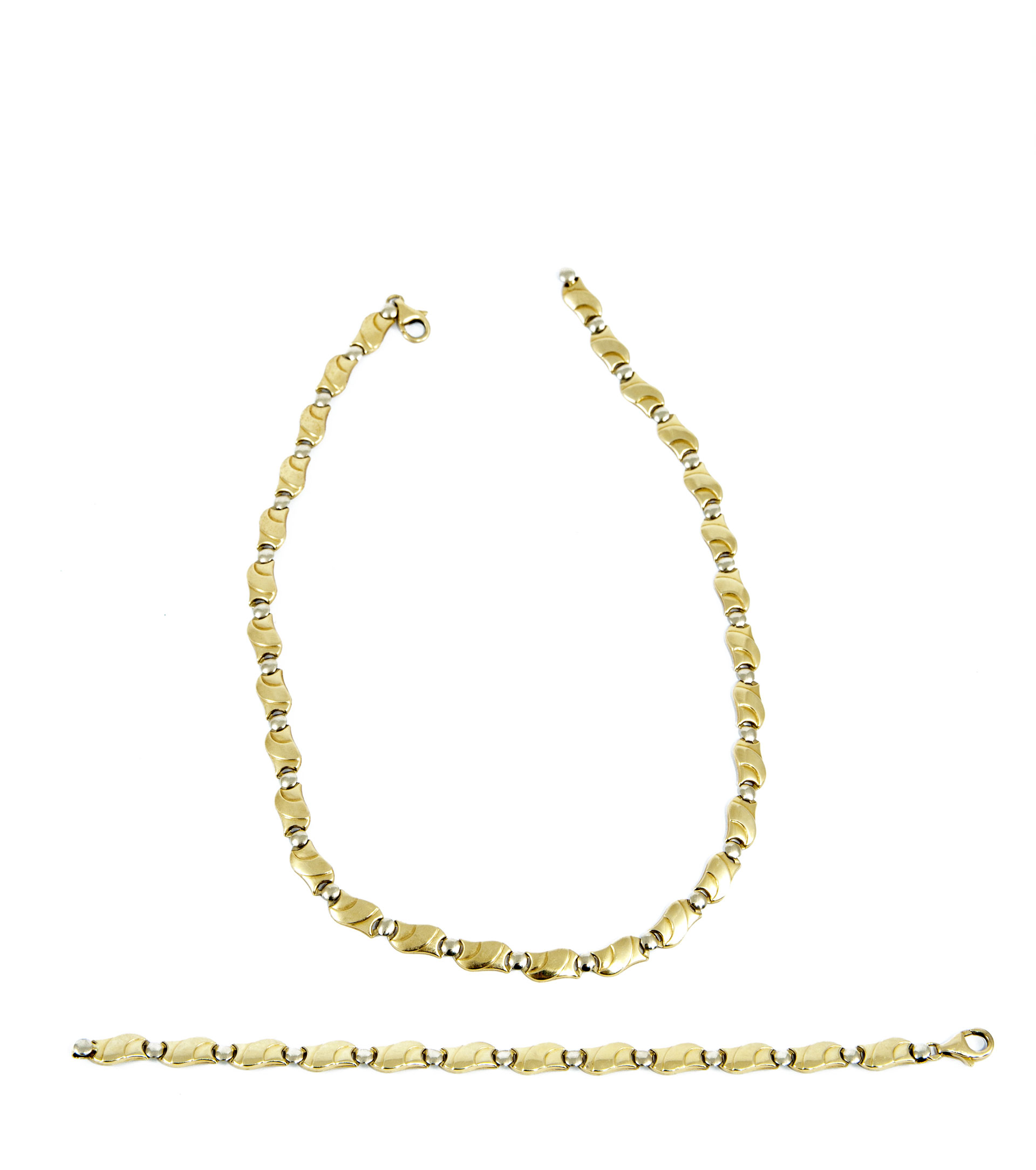 two gold necklaces laid flat on white background