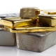 Risks and Rewards of Investing in Precious Metals - several different gold and silver bullion on a white background
