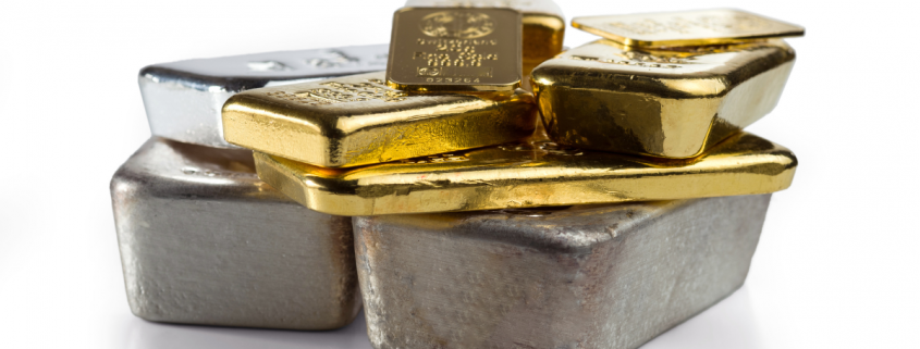 Risks and Rewards of Investing in Precious Metals - several different gold and silver bullion on a white background
