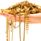 Selling Your Gold Jewelry: Here's What to Expect - hand holding a pile of gold jewelry