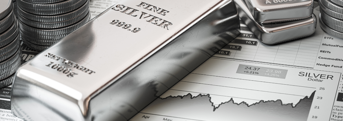 What is a Silver Exchange? silver bars and coins on top of a financial report showing growth of silver prices