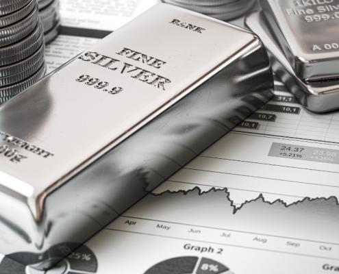 What is a Silver Exchange? silver bars and coins on top of a financial report showing growth of silver prices