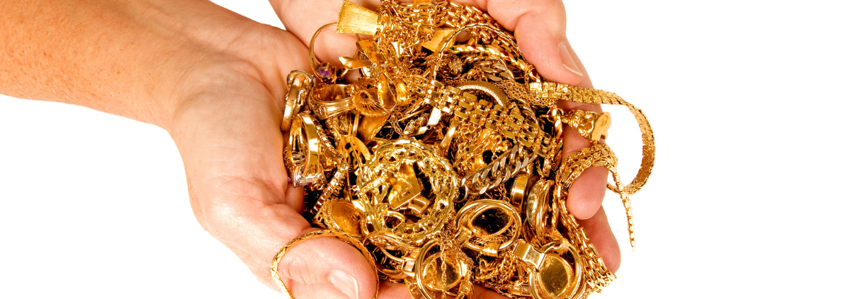 How to Avoid Getting Ripped Off When Selling Your Gold Jewelry - close up of gold jewelry held in two hands close together