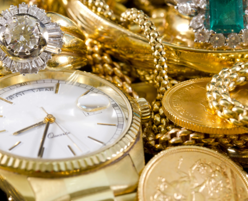 Should I Only Sell My Gold to a Buyer with XRF? - closeup of gold watch, rings, chains, bracelets, and coins