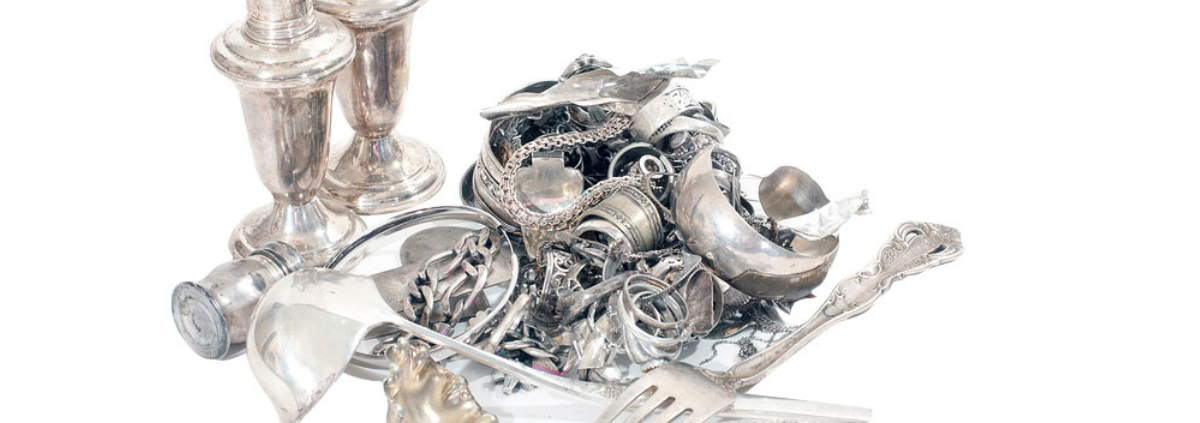 What is the Safest Way to Sell Silver? pile of silver jewelry, silverware, and other silver household items