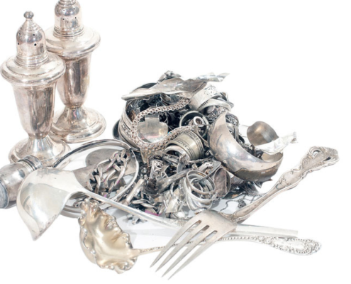 What is the Safest Way to Sell Silver? pile of silver jewelry, silverware, and other silver household items