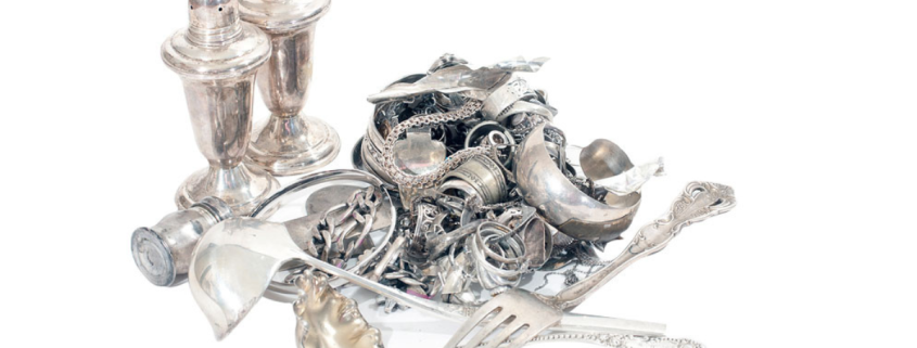 What is the Safest Way to Sell Silver? pile of silver jewelry, silverware, and other silver household items