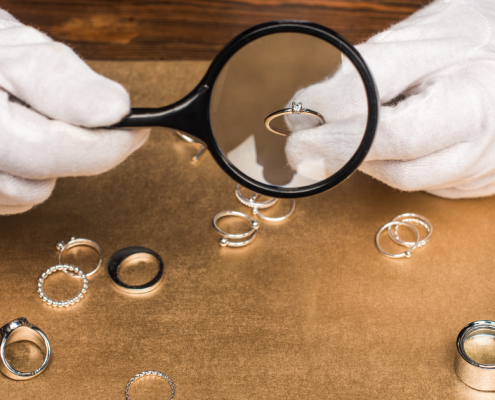 Why Can't I Sell My Diamond Ring for What I Paid for It? closeup of jewelry appraiser holding ring under magnifying glass