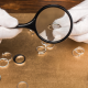 Why Can't I Sell My Diamond Ring for What I Paid for It? closeup of jewelry appraiser holding ring under magnifying glass