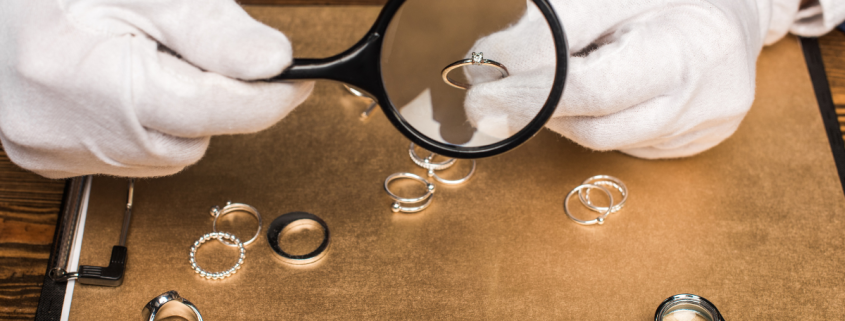 Why Can't I Sell My Diamond Ring for What I Paid for It? closeup of jewelry appraiser holding ring under magnifying glass