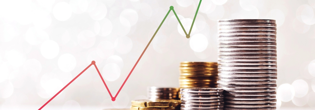 upward trending graph with gold and silver coins stacked below